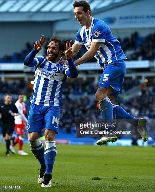 Inigo Calderon of Brighton celebrates with team mate Lewis Dunk after he scores his second and the team's fourth goal of the game during the Sky Bet...
