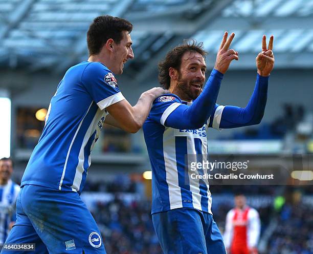 Inigo Calderon of Brighton celebrates with team mate Lewis Dunk after he scores his second and the team's fourth goal of the game during the Sky Bet...