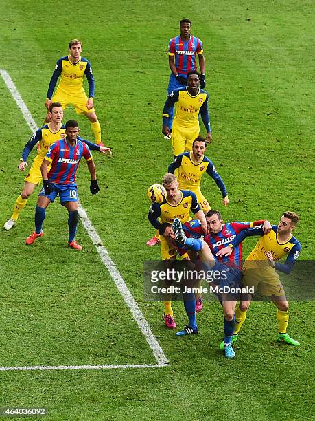 Per Mertesacker of Arsenal, Damien Delaney of Crystal Palace, Jordon Mutch of Crystal Palace and Calum Chambers of Arsenal battle for the ball during...