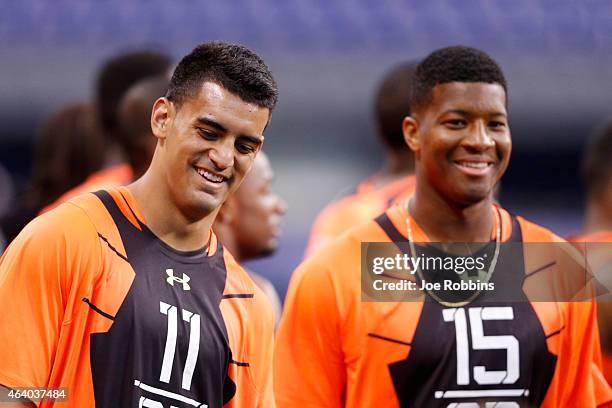 Quarterbacks Marcus Mariota of Oregon and Jameis Winston of Florida State look on during the 2015 NFL Scouting Combine at Lucas Oil Stadium on...