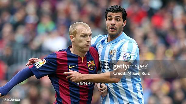 Mathieu of FC Barcelona competes for the ball with Miguel Torres of Malaga CF during the La Liga match between FC Barcelona and Malaga CF at Camp Nou...