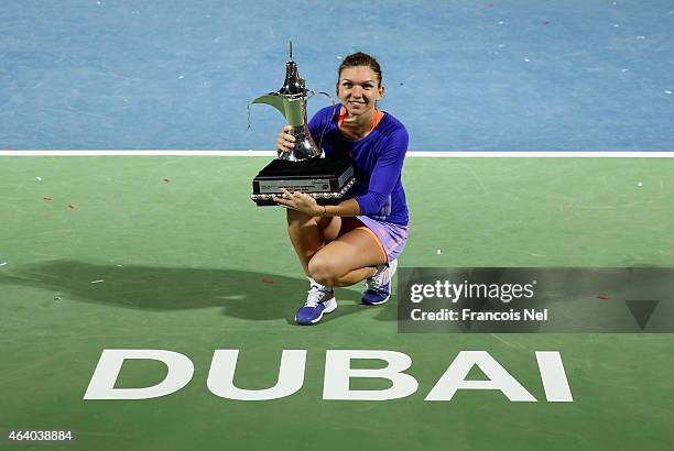 Simona Halep of Romania holds the trophy after defeating Karolina Pliskova of the Czech Republic during their women's final match of the WTA Dubai...