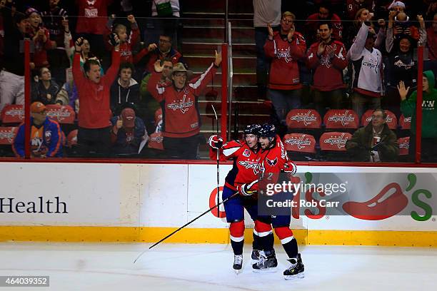 Matt Niskanen of the Washington Capitals celebrates with Nicklas Backstrom after scoring a first period goal against the New York Islanders at...