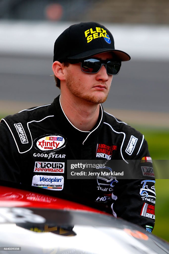 Harrison Rhodes Racing Harrison Rhodes, driver of the Flex Seal Colors Chevrolet, walks on ...