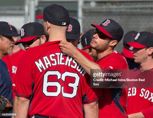 Joe Kelly of the Boston Red Sox checks the tag on teammate Justin Masterston's jersey during a Spring Training workout at Fenway South on February...