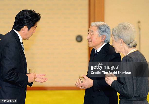 Emperor Akihito and Empress Michiko talk to Prime Minister Shinzo Abe at a tea party for staff involved in the previous imperial visit to India at...