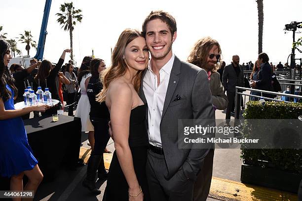 Actors Blake Jenner and Melissa Benoist pose outside the FIJI Water tent during the 30th Annual Film Independent Spirit Awards at Santa Monica Beach...