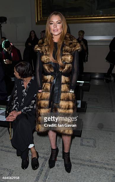 Lindsay Lohan attends the Gareth Pugh show during London Fashion Week Fall/Winter 2015/16 at Victoria & Albert Museum on February 21, 2015 in London,...
