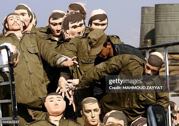 Dummies depicting Israeli soldiers are unloaded from a truck during the shooting of a movie telling the story of a member of Shiite movement...