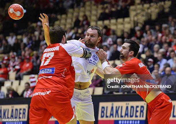 Macedonia's centre back Nemanja Pribak vies with Iceland's pivot Sverre Jakobsson and right back Asgeir Orn Hallgrimsson during the men's EHF Euro...