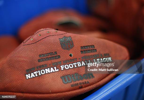 Detail photo of a football after being stamped with the opponents names Super Bowl XLVIII at the Wilson Sporting Goods football factory on January...