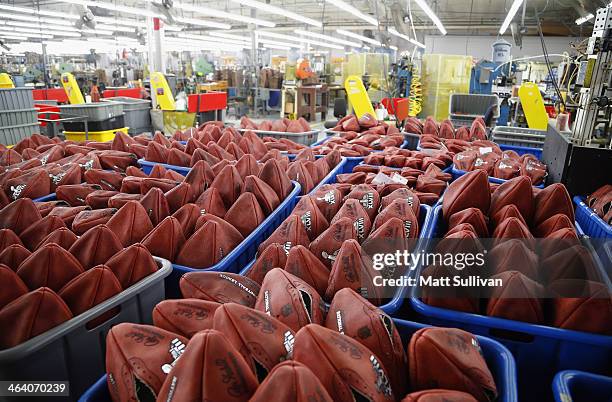 Footballs wait to be stamped with the opponents names for Super Bowl XLVIII at the Wilson Sporting Goods football factory on January 19, 2014 in Ada,...