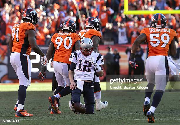 Denver Broncos defensive tackle Terrance Knighton and the Broncos celebrate after sacking New England Patriots quarterback Tom Brady for a 10 yard...