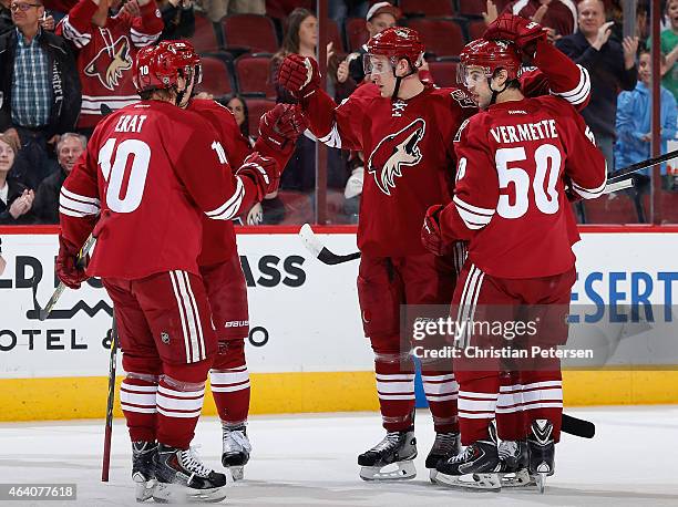 Michael Stone of the Arizona Coyotes celebrates with Martin Erat and Antoine Vermette after Stone scored a first period goal against the Tampa Bay...