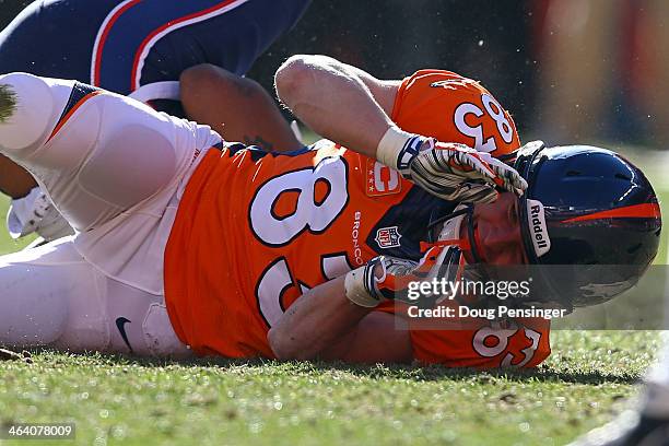 Wes Welker of the Denver Broncos falls on the ground after colliding with Aqib Talib of the New England Patriots during the AFC Championship game at...