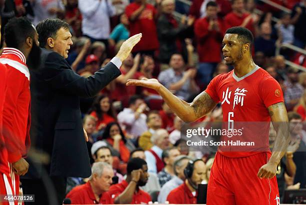 Terrence Jones of the Houston Rockets is greeted near the bench area by head coach Kevin McHale and James Harden during their game against the...