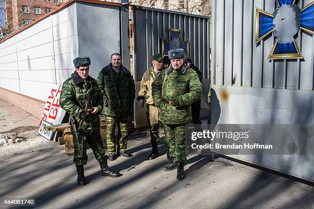 Pro-Russian rebels stand outside the gate to one of their bases on February 21, 2015 in Donetsk, Ukraine. A ceasefire agreement between rebels and...