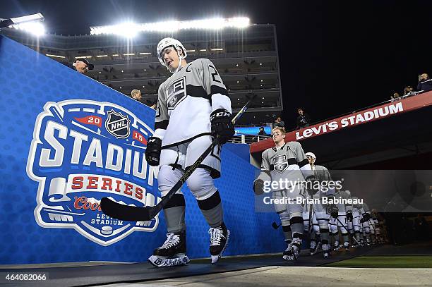 Dustin Brown of the Los Angeles Kings and his teammates walk to the ice surface for warm-up prior to the 2015 Coors Light NHL Stadium Series game...