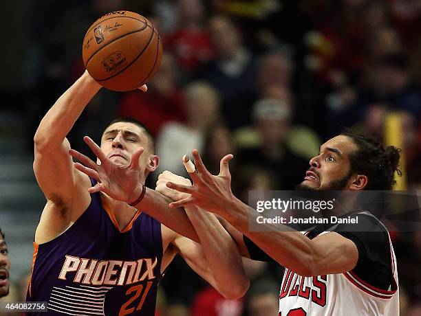 Alex Len of the Phoenix Suns and Joakim Noah of the Chicago Bulls battle for a rebound at the United Center on February 21, 2015 in Chicago,...