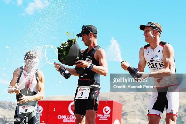 Courtney Ogden of Australia, Dylan McNeice of New Zealand and Dougal Allan of New Zealand celebrate on the podium following the Challenge Wanaka on...