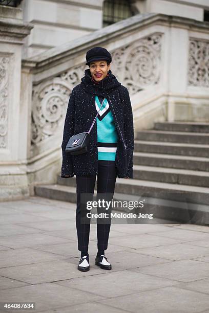 Tamu McPherson wears a Geraldina jacket, Jonathan Saunders sweater, mens MSGM trousers, J. Crew shows, a Louis Vuitton bag, and Borsalino hat during...