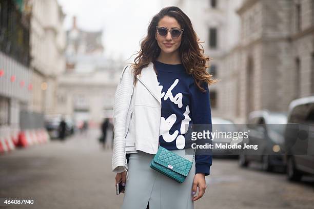 Tamara Colliner wears a House of Holland top, Topshop sunglasses and skirt, Jimmy Choo shoes, and Chanel bag during London Fashion Week Fall/Winter...
