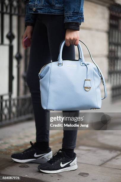 Model Luping Wong exits the Emilia Wickstead show in a MO&Co outfit with a Michael Kors bag and Nike trainers during London Fashion Week Fall/Winter...