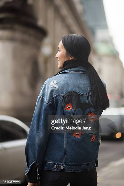 Model Luping Wong exits the Emilia Wickstead show in a MO&Co outfit with a Michael Kors bag and Nike trainers during London Fashion Week Fall/Winter...