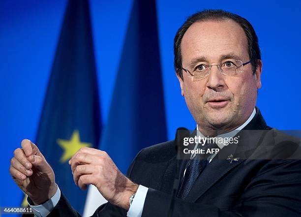 French President Francois Hollande speaks after a round table meeting with respective trade and industry delegation members at the Scheepvaart museum...