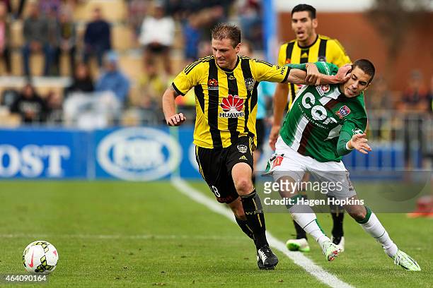 Ben Sigmund of the Phoenix holds off the challenge of Radovan Pavicevic of the Jets during the round 18 A-League match between Wellington Phoenix and...