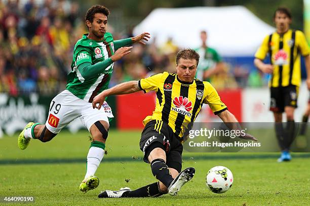 Ben Sigmund of the Phoenix clears the ball under pressure from Mitch Cooper of the Jets during the round 18 A-League match between Wellington Phoenix...