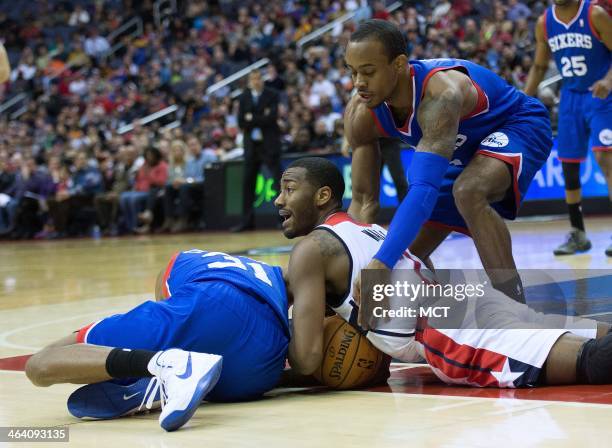 Washington Wizards point guard John Wall tries to call a timeout while battling for the ball with Philadelphia 76ers shooting guard Hollis Thompson ,...