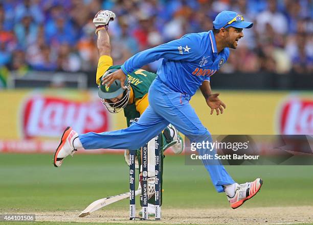 Suresh Raina of India attempts unsuccessfully to run out Hashim Amla of South Africa bats during the 2015 ICC Cricket World Cup match between South...