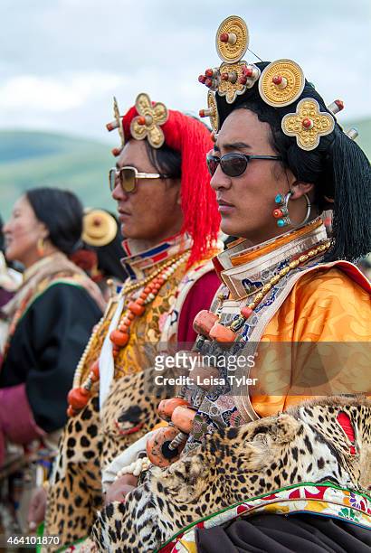 Khampa horseman, dressed in their finest and most decorative outfits, which include rare red coral, amber and turquoise jewels, endangered snow...