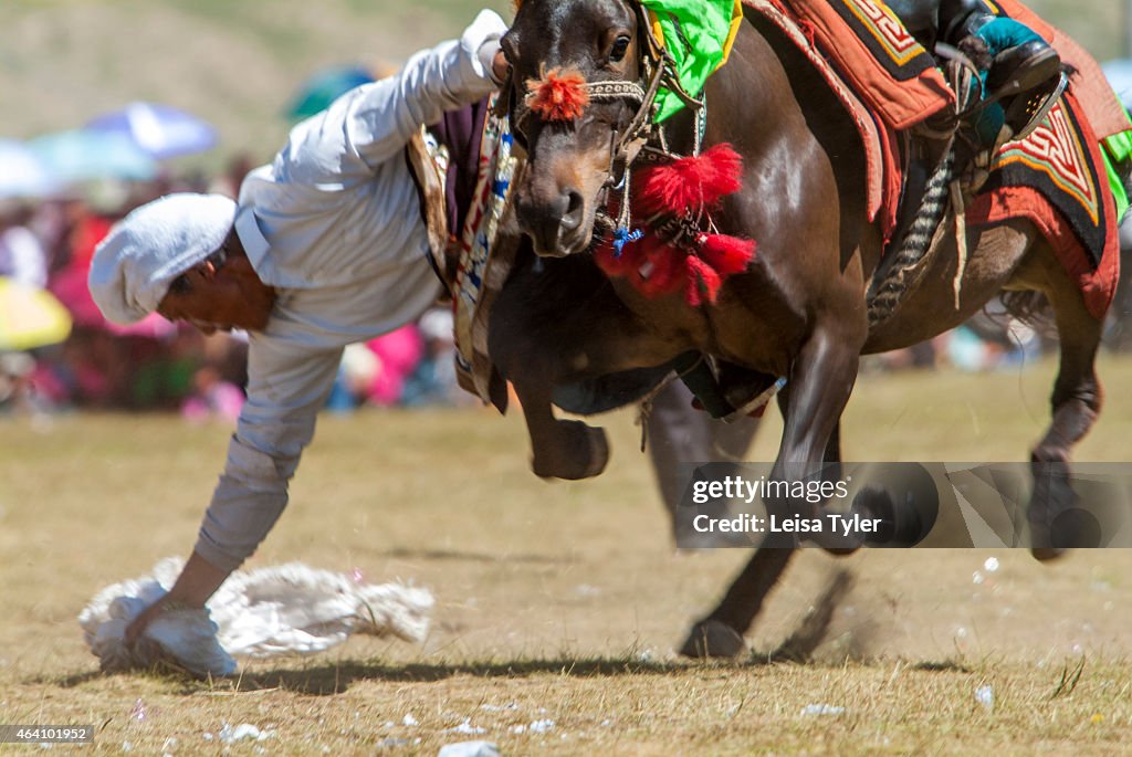 A Khampa horseman practices picking up silk scarves from the...