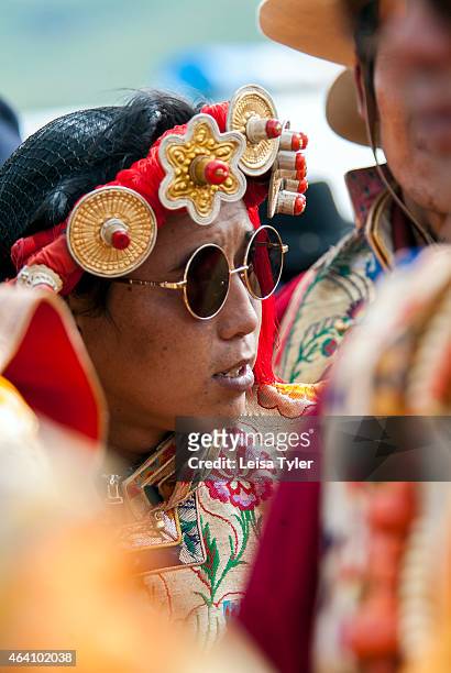 Khampa horseman, dressed in their finest and most decorative outfits, which include rare red coral, amber and turquoise jewels, endangered snow...