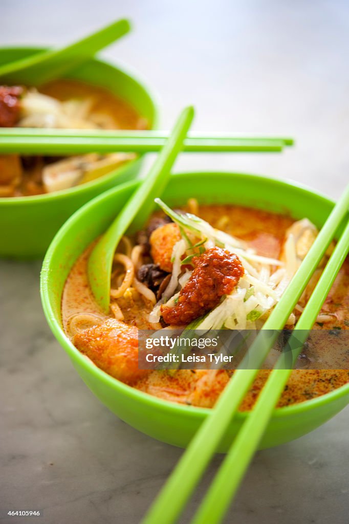 A bowl of laksa, a spicy noodle soup from the Peranakan or...