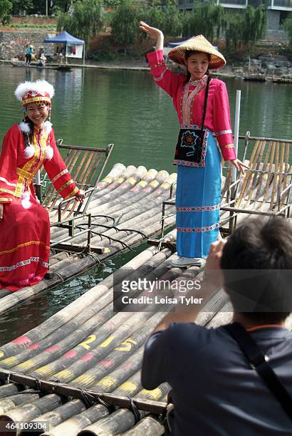 Tourists dress up as local village girls in Yangshuo, a region of karst mountains and the gently flowing Li River outside of Guilin. The last few...
