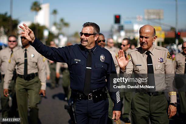 Los Angeles Police Chief Charlie Beck and retiring Los Angeles County Sheriff Lee Baca march in the 29th annual Kingdom Day Parade on January 20,...