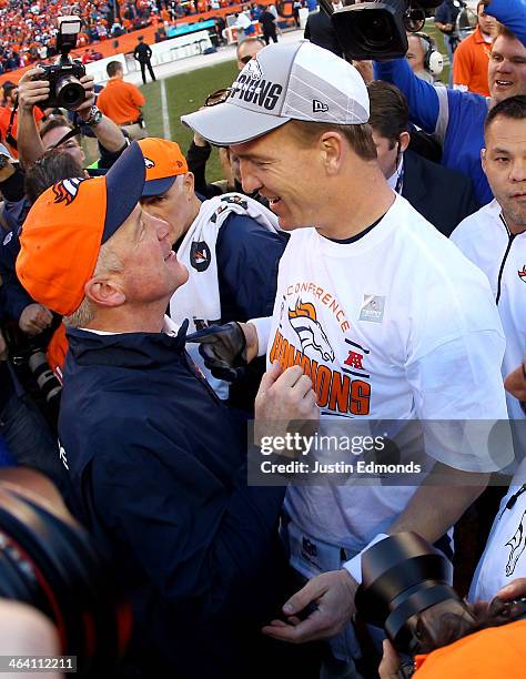 Peyton Manning embraces head coach John Fox of the Denver Broncos after they defeated the New England Patriots 26 to 16 during the AFC Championship...