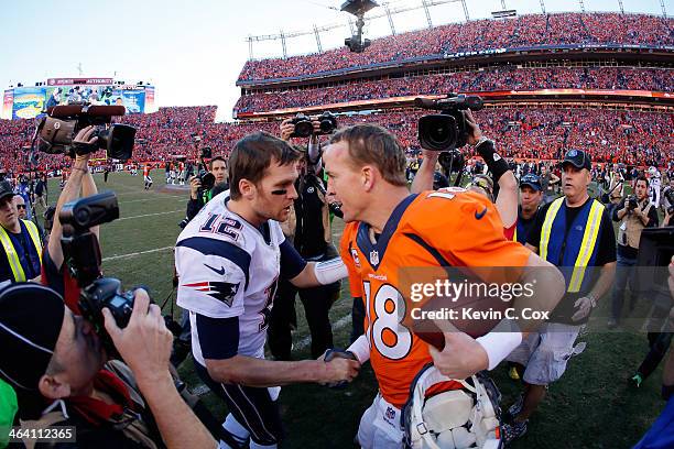 Tom Brady of the New England Patriots congratulates Peyton Manning of the Denver Broncos after the Broncos defeated the Patriots 26 to 16 during the...