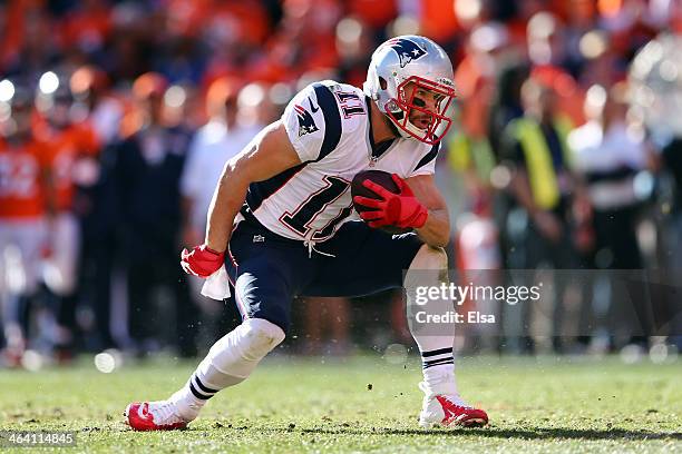 Julian Edelman of the New England Patriots avoids a tackle against the Denver Broncos during the AFC Championship game at Sports Authority Field at...