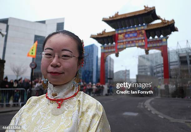 Woman wearing traditional clothing poses in front of the ceremonial archway as the Chinese community come together to welcome in the Chinese New Year...