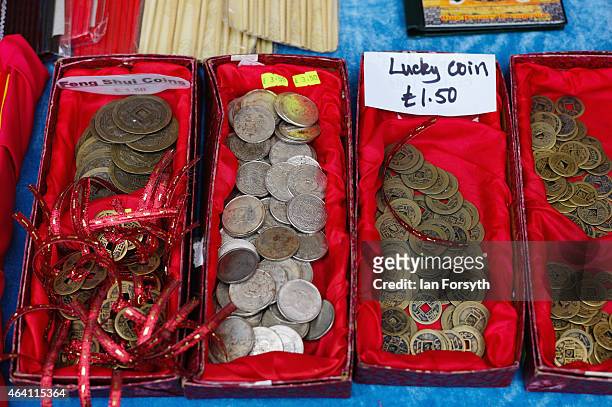 Chinese lucky coins are offered for sale at a stall as the Chinese community come together to welcome in the Chinese New Year on February 22, 2015 in...