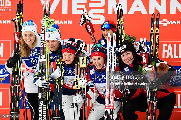 Gold medallists Ingvild Flugstad Oestberg and Maiken Caspersen Falla of Norway pose with silver medallists Ida Ingemarsdotter and Stina Nilsson of...