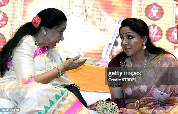 Indian Bollywood playback singer Asha Bhosle and actress Hema Malini speak during a devotional album and book launch of Veena Mundhra's Shri Hari...