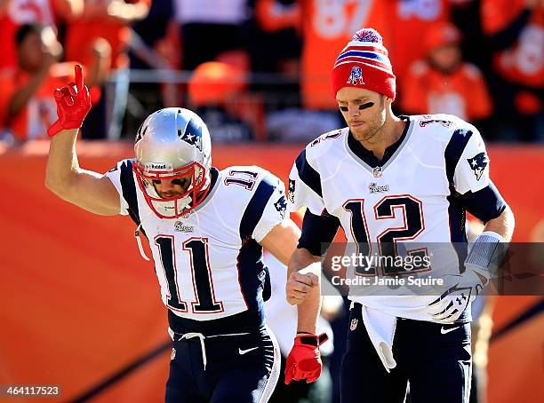 Tom Brady and Julian Edelman of the New England Patriots take the field prior to the AFC Championship game against the Denver Broncos at Sports...