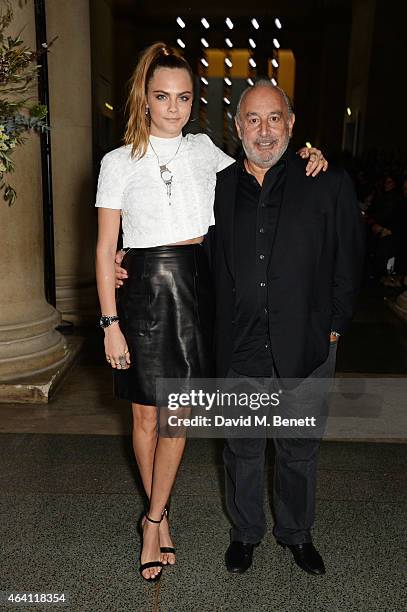 Cara Delevingne and Sir Philip Green attend the Topshop Unique show during London Fashion Week Fall/Winter 2015/16 at Tate Britain on February 22,...