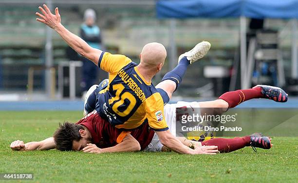 Emil Hallfredsson of Hellas Verona is tackled by Davide Astori of AS Roma during the Serie A match between Hellas Verona FC and AS Roma at Stadio...