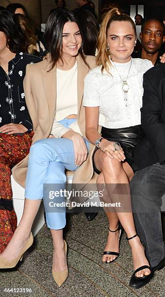 Kendall Jenner and Cara Delevingne attend the Topshop Unique show during London Fashion Week Fall/Winter 2015/16 at Tate Britain on February 22, 2015...